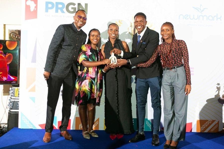 Award winners holding a trophy