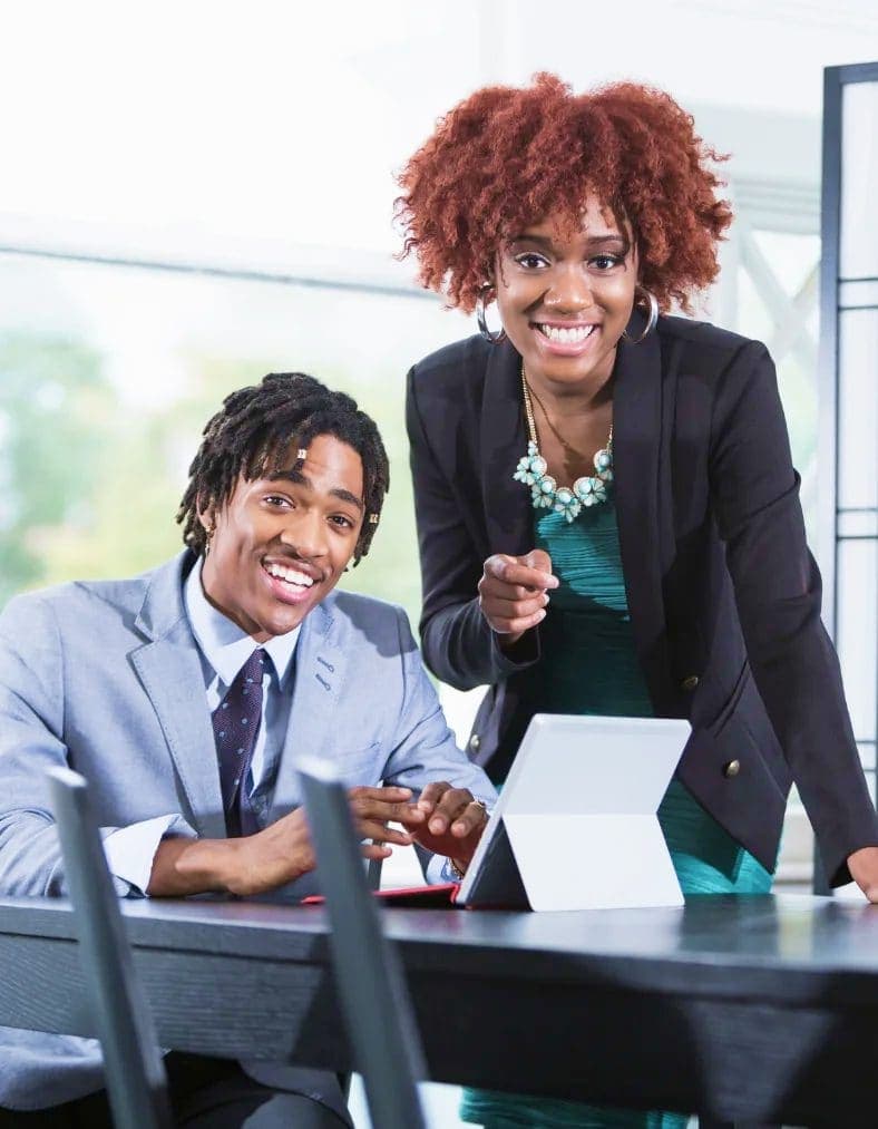 Smiling team members with a tablet